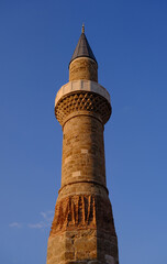 historical Broken Minaret of oldtown, Antalya, Turkey with sky and red clouds.