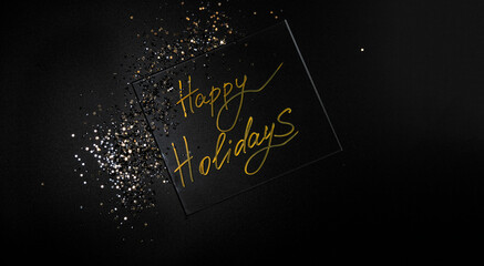 Happy Holidays. Beautiful sparkling Golden Happy Holidays on a black background for a design With Space For Copying Text. A beautiful glowing overlay template for a festive greeting card.