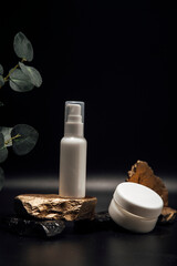 The composition of bottles of cosmetics for face care. A tube of gel, a jar of cream, empty packages without a brand. Advertising of skin care products