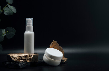 The composition of bottles of cosmetics for face care. A tube of gel, a jar of cream, empty packages without a brand. Advertising of skin care products