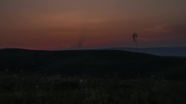 Sunset timelapse. The sun is setting behind the mountains. Taken on the "lens baby" with the effect titl shift