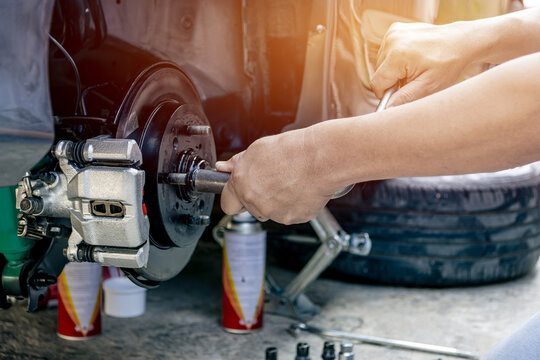 Close up hand a man repairing and Simple test bolt of car wheel after repair paint and  maintenance that can be made by yourself