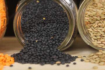 Dried Black, Green and Orange Lentils on Wooden Table