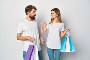 cheerful young couple with packages in their hands shopping entertainment friendship