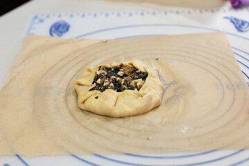 Single savoury pastry filled with feta cheese, spiniach and onion
