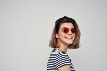 cheerful fashionable woman wearing glasses striped t-shirt posing modern style