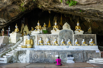 Myanmar (formerly Burma). Karen State. Hpa Han. Woman praying Buddha at Ya Teak Pyan cave