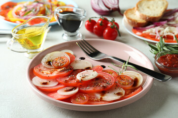 Concept of tasty food with tomato carpaccio on white textured table