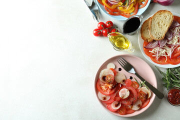 Concept of tasty food with tomato carpaccio on white textured table