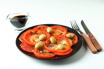 Concept of tasty food with tomato carpaccio on white background