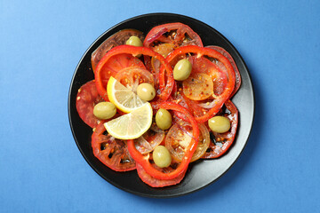 Concept of tasty food with tomato carpaccio on blue background