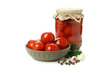 Jar and bowl with pickled tomatoes isolated on white background
