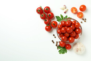 Bowl with pickled tomatoes and ingredients on white background