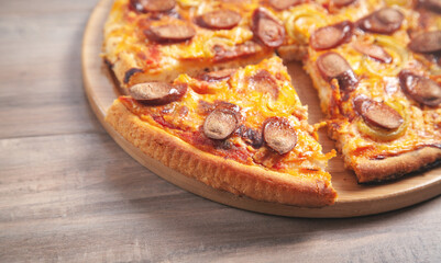 Pizza on wooden table background.