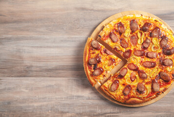 Pizza on wooden table background.