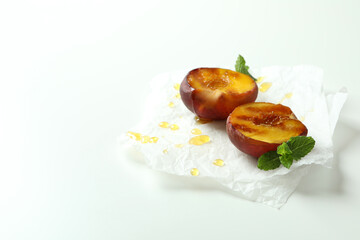 Grilled peach with honey on white background