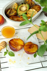 Concept of tasty food with grilled peach on white wooden table