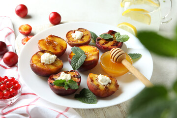 Concept of tasty food with plate with grilled peach