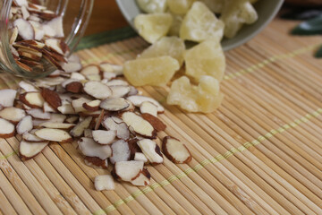 Sliced Almonds and Dried Pineapple on Bamboo Mat Close up