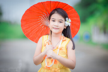 Close-up background view of a blurred Asian girl running or teasing in the street in front of the...