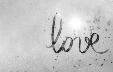 winter glass with sun, inscription love on frozen glass, Valentine's Day card