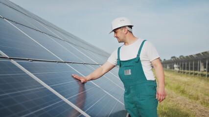 Engineer expert in solar energy photovoltaic panels. Man in hard helmet examining object. Concept of solar station development and green energy. Technology. Ecological concept.