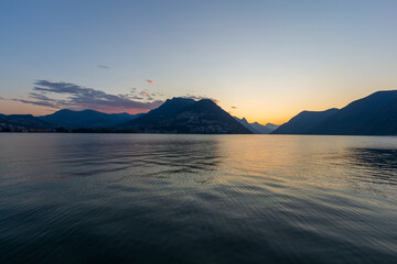 Panoramic view at sunrise time with hills on the lake Lugano, Paradiso, Switzerland