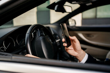 Naklejka premium A professional manager in a business suit answers a voice message to clients. The entrepreneur is in the car. The lawyer holds the phone in his hand and calls.