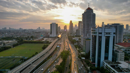 Fototapeta na wymiar Aerial view of Panoramic photo of Jakarta overlooking Parklands, and the city skyline with a spectacular sunset. Jakarta, Indonesia, August 13, 2021