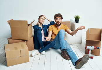 young couple moving boxes with things home routine