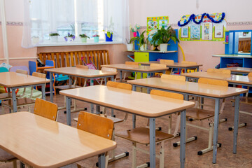 Fototapeta na wymiar Tables and chairs for preschool and school educational premises, for children to study general subjects.