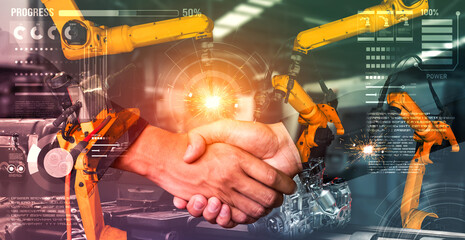 Mechanized industry robot arm and business handshake double exposure . Concept of successful...