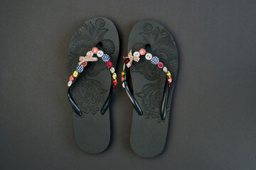 flip-flops on a black background. Beach slippers close-up