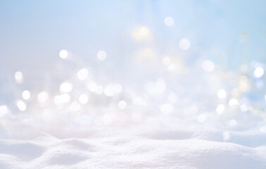 Festive Christmas natural snowy background, abstract empty stage, snow, snowdrift and defocused Christmas lights on light blue background, copy space.