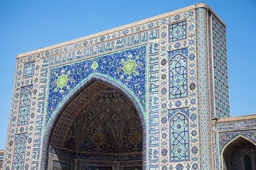 Fragment of the facade of the Tillya-Kari Madrasah, decorated with mosaics, on Registan Square in Smarkand in Uzbekistan. 29.04.19