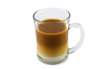 Two layers of milk coffee in a transparent glass, perspective view,  isolated on a white background