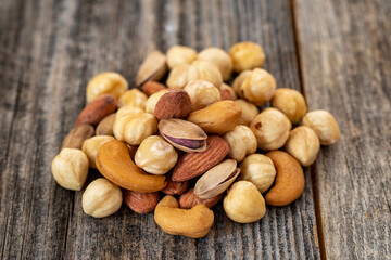 Mixed nuts on wood floor. Organic and fresh nuts. close up