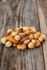 Mixed nuts on wood floor. Organic and fresh nuts. close up