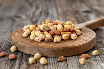 Mixed nuts on wood floor. Organic and fresh nuts. close up