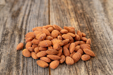 Almond nuts on wood background. Organic and fresh nuts. close up