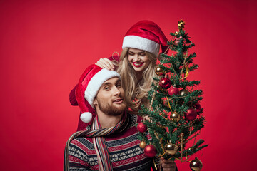 Fototapeta na wymiar Cheerful young couple New Year in a place of Christmas holiday