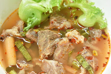 hot and spicy beef meat with tamarind and Thai herbs soup on bowl