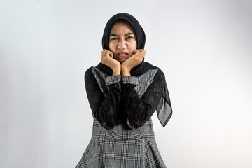 Beautiful young asian muslim woman disgusted, disliked, horrified, scared, looking at camera...