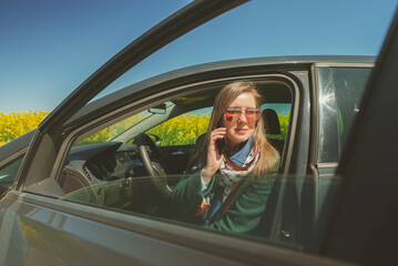Woman calling by smartphone from the car.