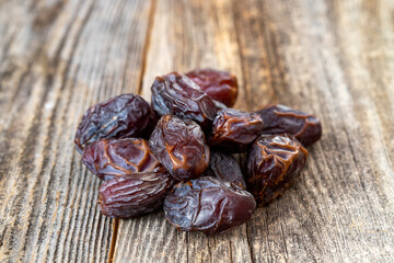 Date fruit on wood background. Organic and fresh nuts. close up