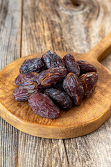 Date fruit on wood background. Organic and fresh nuts. close up
