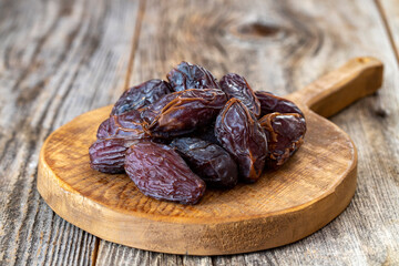 Date fruit on wood background. Organic and fresh nuts. close up