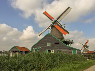 Fototapeta na wymiar Collection of Dutch windmills and buildings in Zaanse