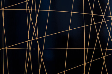 Yellow straight lines randomly distributed on a dark background, a beautiful geometric background....