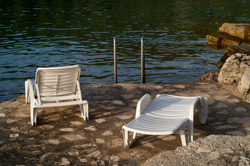 Obraz na płótnie Canvas White plastic beach chair on the Croatian sea coast